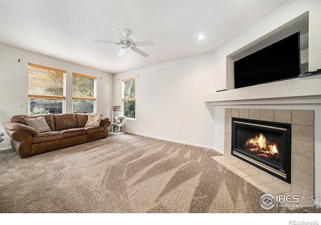 1874 Ute Creek Dr, Longmont, CO 80504 - carpeted living room featuring a tiled fireplace, a ceiling fan, baseboards, and recessed lighting