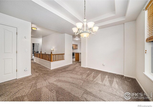 1874 Ute Creek Dr, Longmont, CO 80504 - empty room featuring carpet, a chandelier, and baseboards