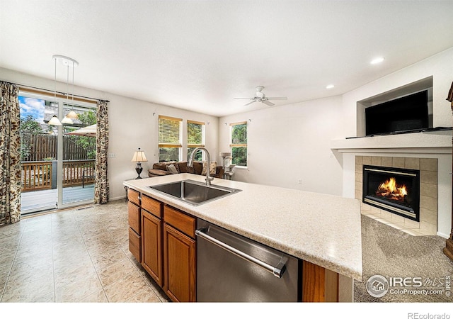 1874 Ute Creek Dr, Longmont, CO 80504 - kitchen with dishwasher, open floor plan, a sink, brown cabinets, and healthy amount of natural light