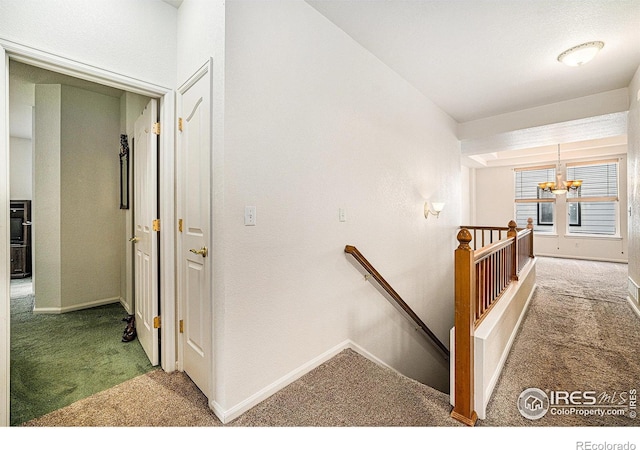 1874 Ute Creek Dr, Longmont, CO 80504 - corridor featuring an upstairs landing, light colored carpet, baseboards, and a chandelier