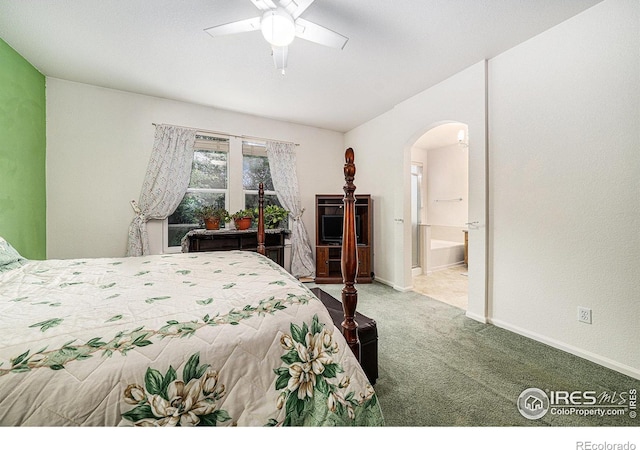 1874 Ute Creek Dr, Longmont, CO 80504 - carpeted bedroom featuring arched walkways, connected bathroom, ceiling fan, and baseboards