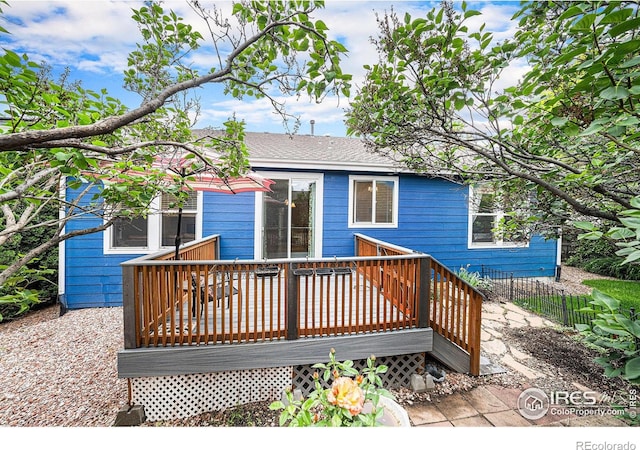 1874 Ute Creek Dr, Longmont, CO 80504 - rear view of property featuring a wooden deck and roof with shingles