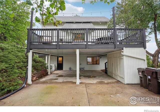 3260 Lafayette Dr, Boulder, CO 80305 - rear view of property featuring a wooden deck, a shingled roof, and driveway