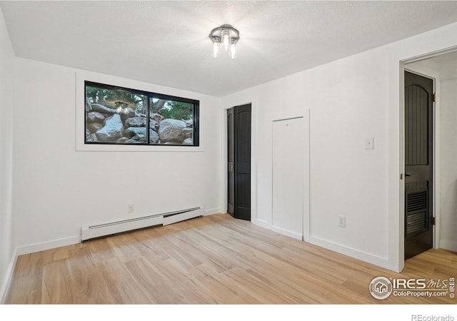 3260 Lafayette Dr, Boulder, CO 80305 - unfurnished bedroom featuring a baseboard radiator, light wood-type flooring, and baseboards