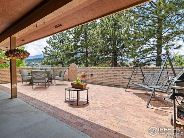 838 Vista Ln, Estes Park, CO 80517 - fenced backyard featuring a gate, a patio, a mountain view, and outdoor dining space