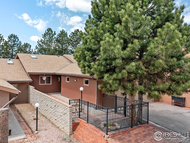 838 Vista Ln, Estes Park, CO 80517 - back of property featuring roof with shingles and stucco siding