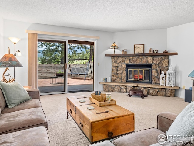 838 Vista Ln, Estes Park, CO 80517 - living area featuring carpet floors, a stone fireplace, and a textured ceiling