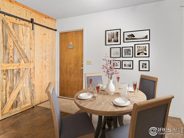 838 Vista Ln, Estes Park, CO 80517 - dining room featuring a barn door and a textured ceiling