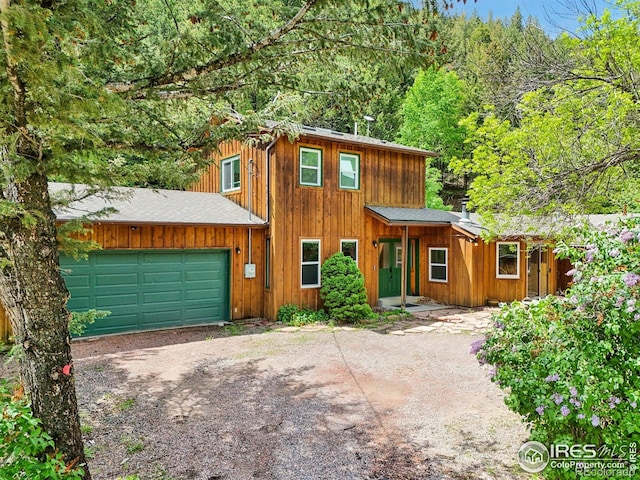 8493 Lefthand Canyon Dr, Jamestown, CO 80455 - chalet / cabin with driveway, an attached garage, and roof with shingles
