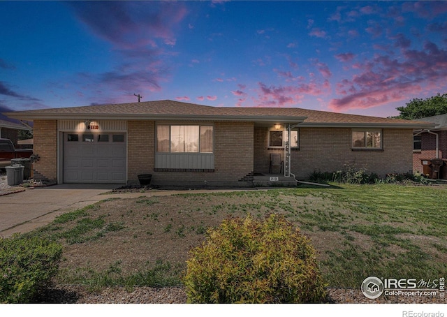213 S 4th St, La Salle, CO 80645 - single story home featuring an attached garage, a front lawn, concrete driveway, and brick siding