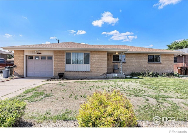 213 S 4th St, La Salle, CO 80645 - ranch-style house with a garage, a front yard, brick siding, and concrete driveway