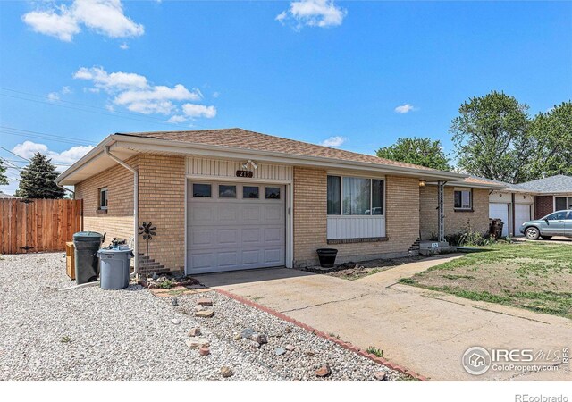 213 S 4th St, La Salle, CO 80645 - ranch-style house featuring an attached garage, brick siding, concrete driveway, and a shingled roof
