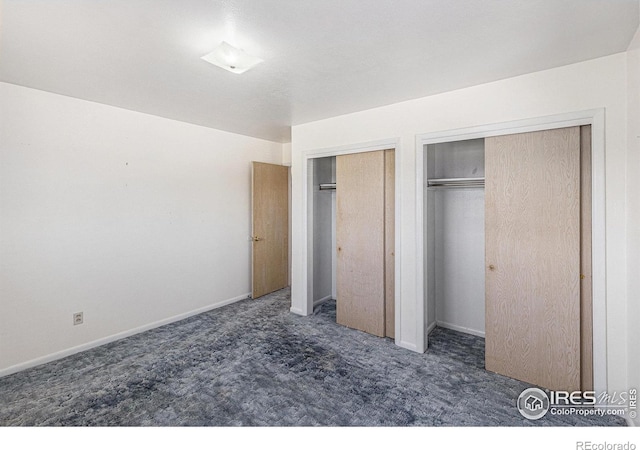 213 S 4th St, La Salle, CO 80645 - unfurnished bedroom featuring two closets, carpet flooring, and baseboards