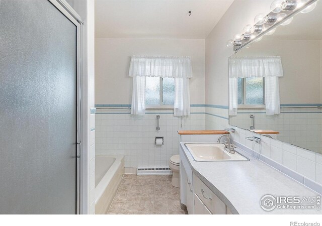 213 S 4th St, La Salle, CO 80645 - full bathroom with a baseboard radiator, healthy amount of natural light, tile patterned floors, vanity, and wainscoting