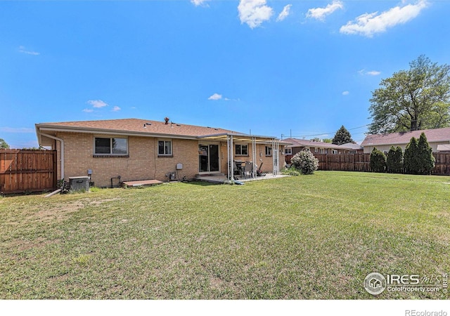 213 S 4th St, La Salle, CO 80645 - back of property featuring brick siding, a patio area, and central AC unit