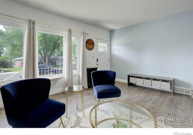 112 Dawson Pl, Longmont, CO 80504 - living area with wood finished floors, a textured ceiling, and baseboards