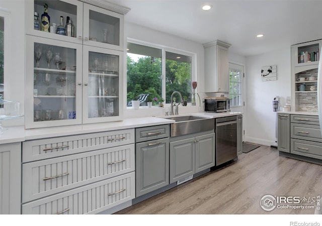 112 Dawson Pl, Longmont, CO 80504 - kitchen featuring gray cabinets, a sink, appliances with stainless steel finishes, light wood-type flooring, and recessed lighting
