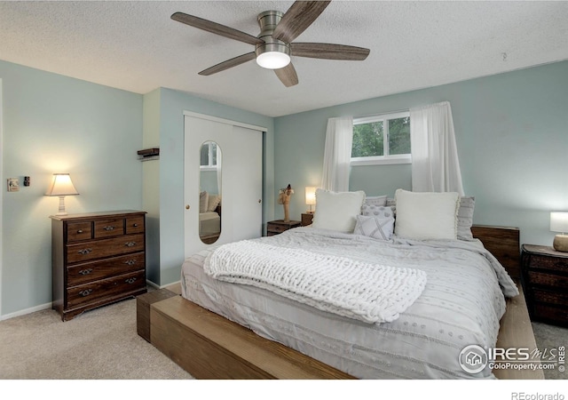 112 Dawson Pl, Longmont, CO 80504 - bedroom with carpet, a closet, a textured ceiling, ceiling fan, and baseboards