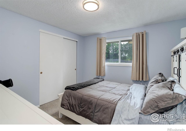 112 Dawson Pl, Longmont, CO 80504 - carpeted bedroom with a closet and a textured ceiling