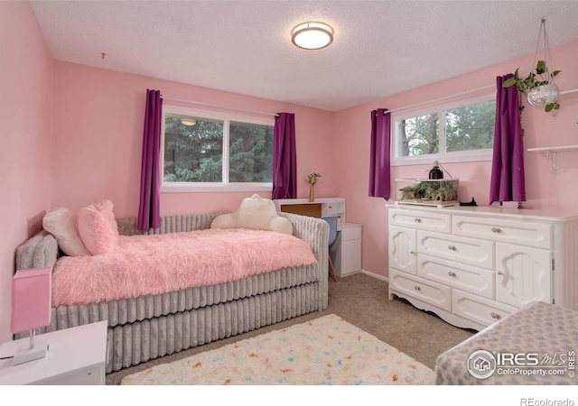 112 Dawson Pl, Longmont, CO 80504 - carpeted bedroom featuring a textured ceiling and baseboards
