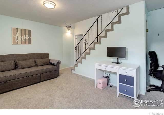 112 Dawson Pl, Longmont, CO 80504 - carpeted living room featuring stairway, a desk, and baseboards