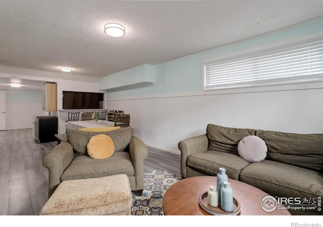 112 Dawson Pl, Longmont, CO 80504 - living room with a textured ceiling, wood finished floors, and baseboards