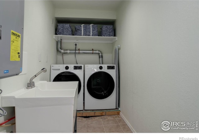 112 Dawson Pl, Longmont, CO 80504 - laundry room featuring washing machine and dryer, baseboards, and tile patterned flooring