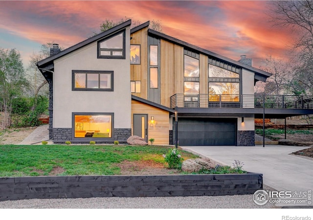 1048 Westview Dr, Boulder, CO 80303 - contemporary home with stone siding, an attached garage, driveway, and a chimney