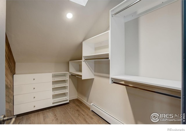1048 Westview Dr, Boulder, CO 80303 - walk in closet featuring a baseboard heating unit, wood finished floors, lofted ceiling, and a skylight