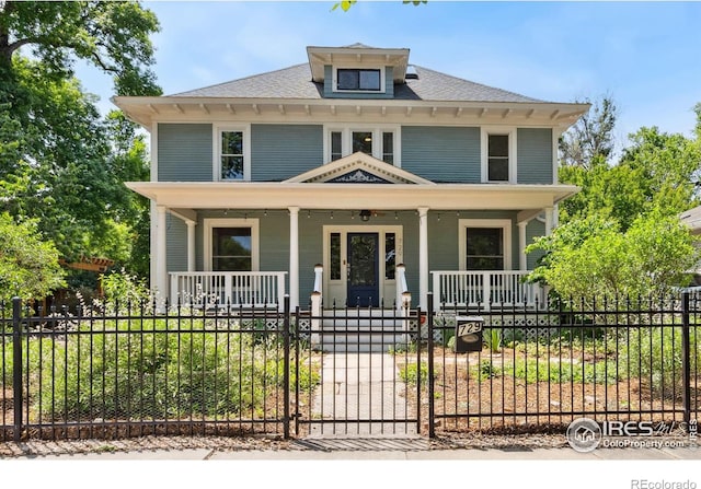 729 Peterson St, Fort Collins, CO 80524 - american foursquare style home with covered porch, a fenced front yard, and roof with shingles