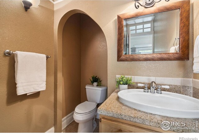 729 Peterson St, Fort Collins, CO 80524 - bathroom featuring a textured wall, toilet, vanity, and tile patterned flooring