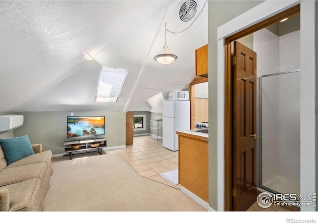 729 Peterson St, Fort Collins, CO 80524 - living room featuring a skylight, lofted ceiling, light colored carpet, baseboards, and light tile patterned floors