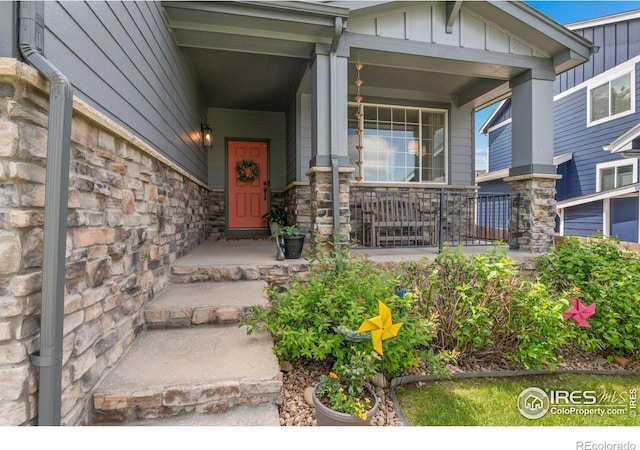 1682 Crestview Ln, Erie, CO 80516 - property entrance featuring stone siding, board and batten siding, and covered porch