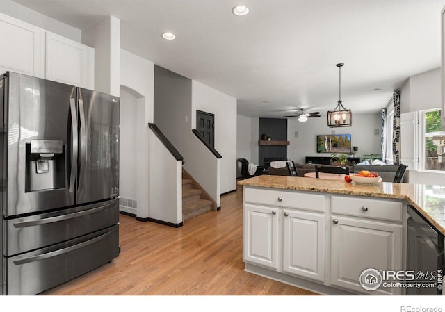 1682 Crestview Ln, Erie, CO 80516 - kitchen with stainless steel fridge, white cabinetry, light wood-style floors, open floor plan, and recessed lighting