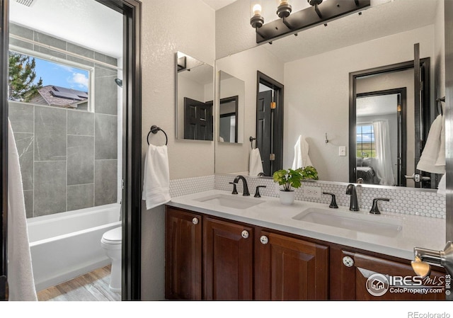 1682 Crestview Ln, Erie, CO 80516 - ensuite bathroom with backsplash, double vanity, wood finished floors, toilet, and shower / bath combination with curtain