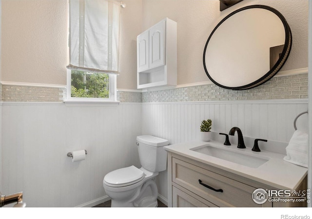 1682 Crestview Ln, Erie, CO 80516 - bathroom featuring wainscoting, toilet, and vanity