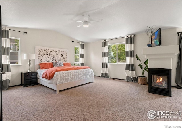 1682 Crestview Ln, Erie, CO 80516 - bedroom featuring carpet, vaulted ceiling, a multi sided fireplace, and ceiling fan