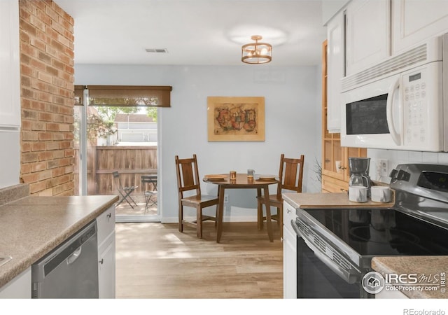 1901 W 101st Ave, Thornton, CO 80260 - kitchen with stainless steel appliances, light wood-style floors, white cabinetry, a chandelier, and baseboards