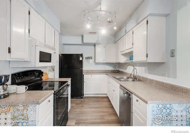 1901 W 101st Ave, Thornton, CO 80260 - kitchen featuring black appliances, a sink, white cabinets, and light wood finished floors