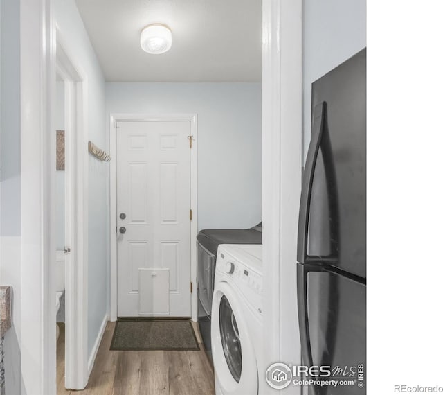 1901 W 101st Ave, Thornton, CO 80260 - washroom with washer and dryer and wood finished floors
