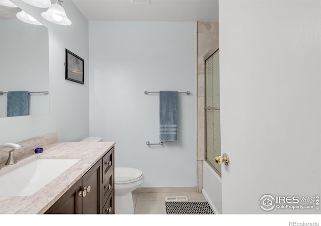 1901 W 101st Ave, Thornton, CO 80260 - full bathroom featuring vanity, toilet, tile patterned floors, enclosed tub / shower combo, and baseboards