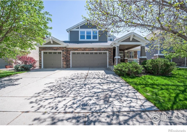 14246 Piney River Rd, Broomfield, CO 80023 - craftsman-style house featuring driveway, a porch, an attached garage, a front yard, and stone siding