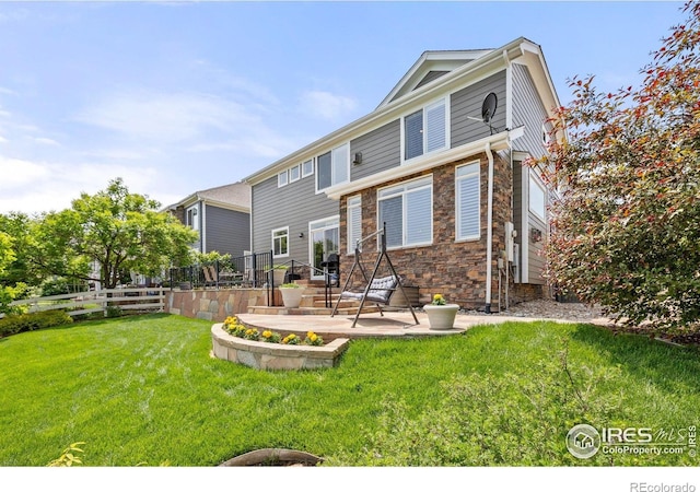 14246 Piney River Rd, Broomfield, CO 80023 - back of property featuring a patio area and stone siding