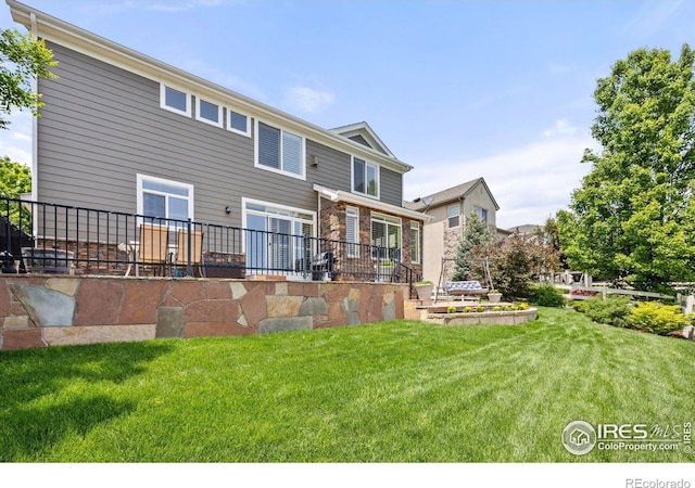 14246 Piney River Rd, Broomfield, CO 80023 - back of property with a lawn and stone siding