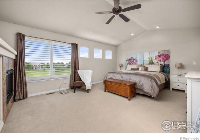 14246 Piney River Rd, Broomfield, CO 80023 - bedroom with light carpet, vaulted ceiling, baseboards, ceiling fan, and a tiled fireplace
