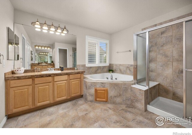 14246 Piney River Rd, Broomfield, CO 80023 - full bathroom with vanity, a garden tub, and a stall shower