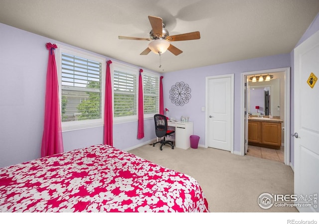14246 Piney River Rd, Broomfield, CO 80023 - bedroom with light colored carpet, a sink, connected bathroom, a ceiling fan, and baseboards