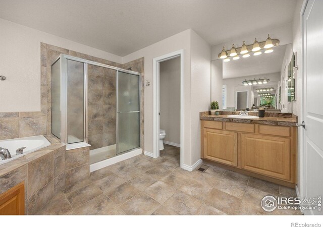 14246 Piney River Rd, Broomfield, CO 80023 - bathroom with vanity, a shower stall, a garden tub, toilet, and baseboards