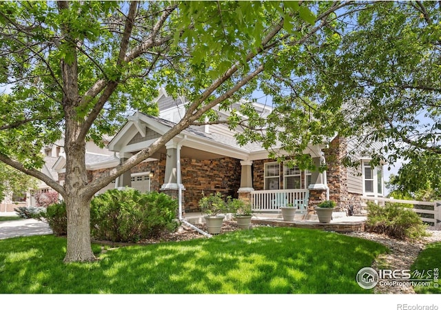 14246 Piney River Rd, Broomfield, CO 80023 - view of front facade featuring covered porch and stone siding