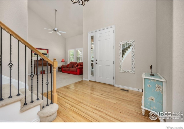14246 Piney River Rd, Broomfield, CO 80023 - foyer featuring wood finished floors, ceiling fan, stairway, high vaulted ceiling, and baseboards